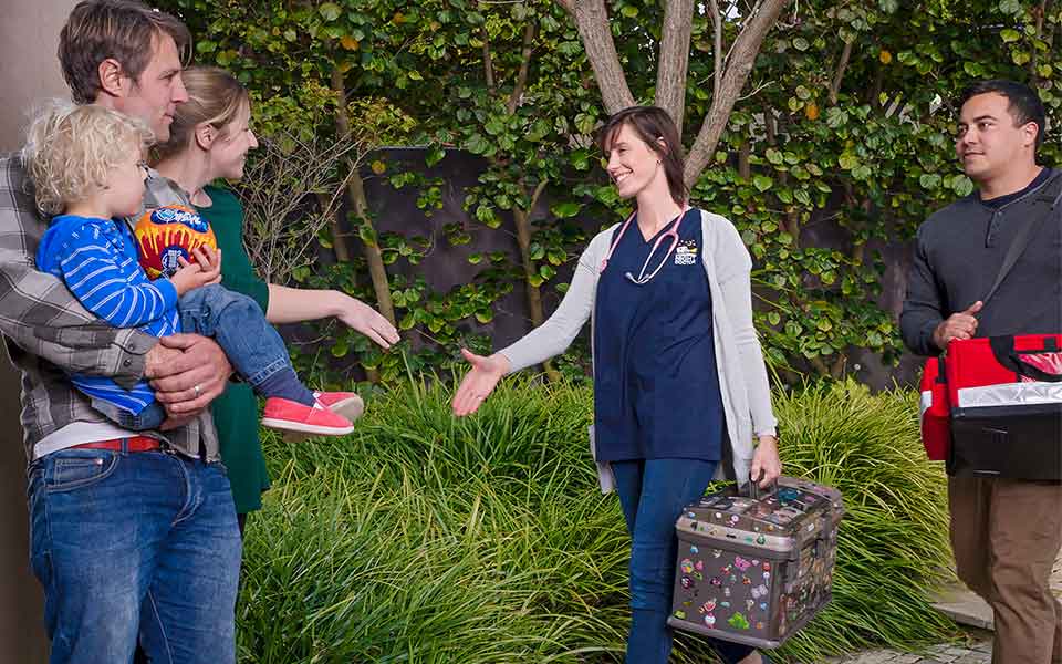 Picture of a home visit doctor in Perth greeting a family at their front door